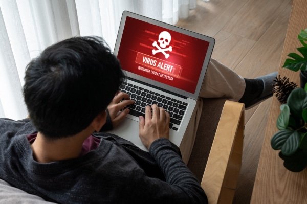 a man sitting on a chair using a laptop