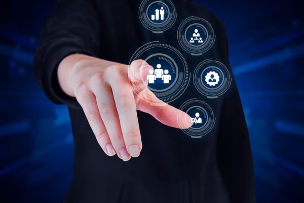 a hand touching a screen with icons