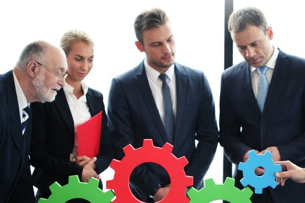a group of people looking at gears