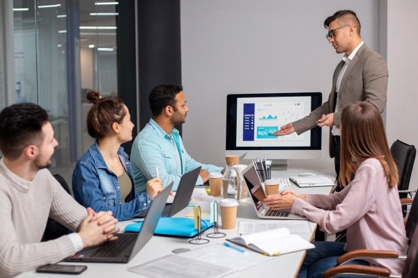 a man standing in front of a computer screen